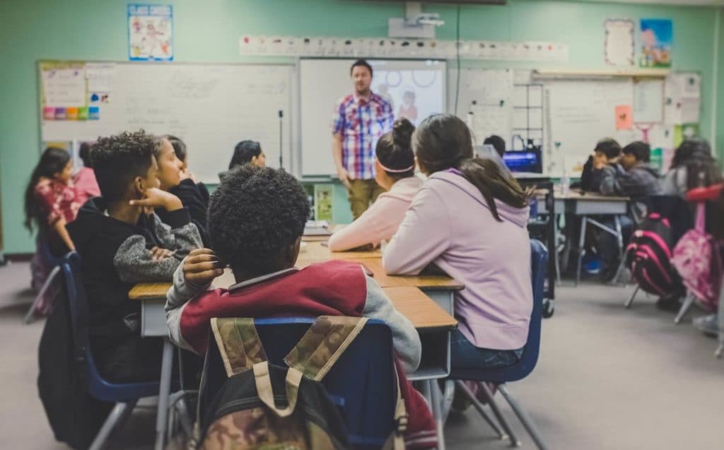 A middle school classroom in which the students are all paying attention to their teacher