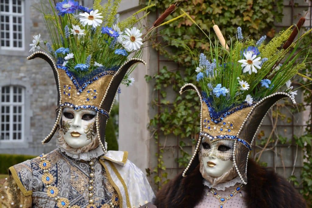 People wearing typical Venetian masks in gold and blue