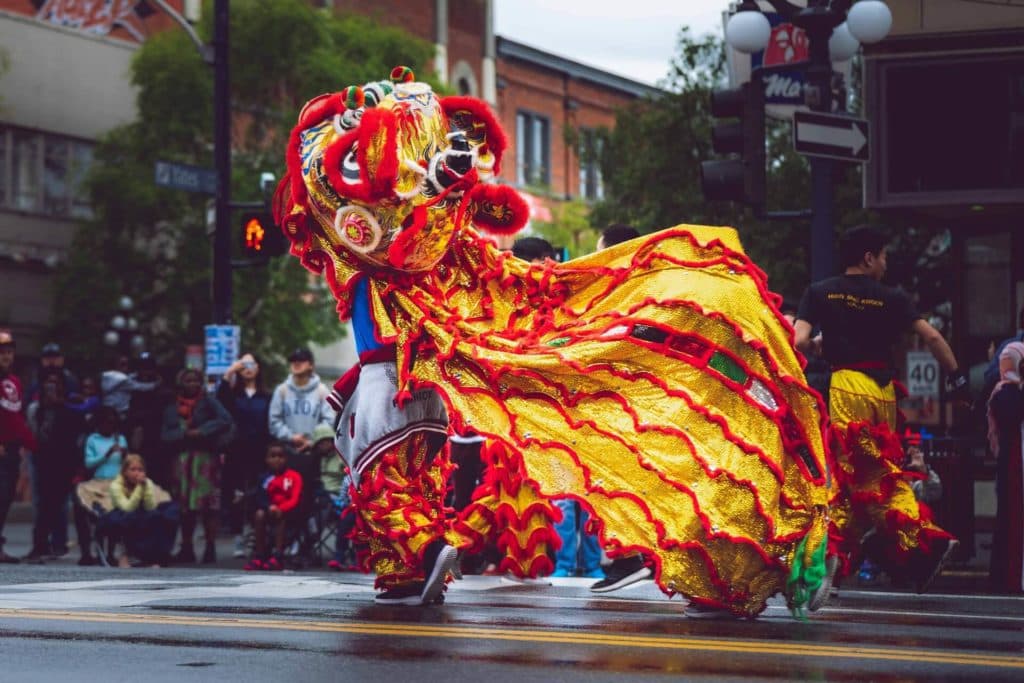 Chinese new year celebrations in the street, people inside the Chinese dragon costume