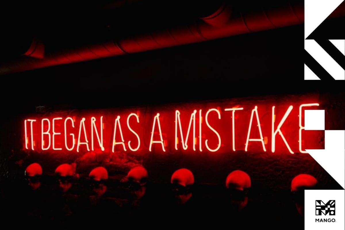 A lit up neon sign that says "It began as a mistake"
