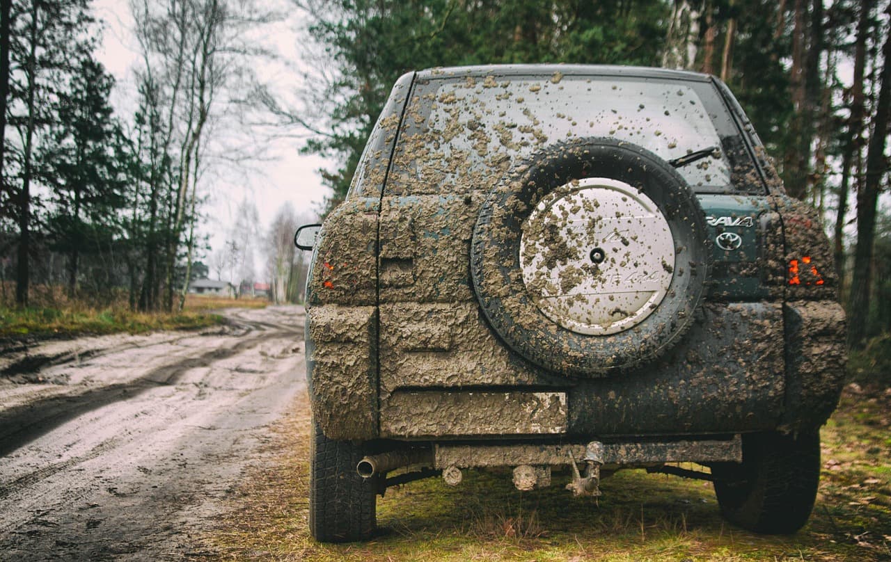 A photo of the back of a very muddy car.