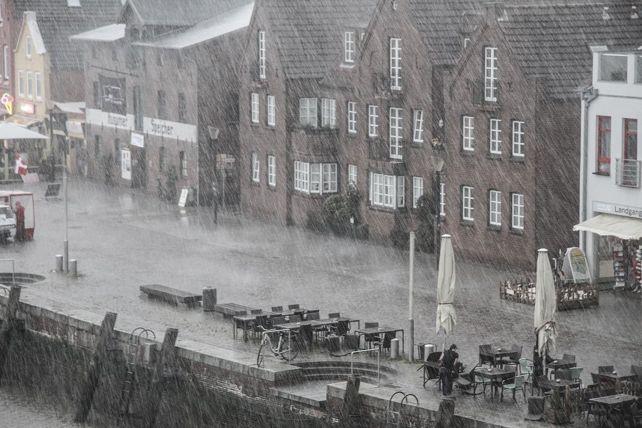 A photo of a European street in pouring rain.