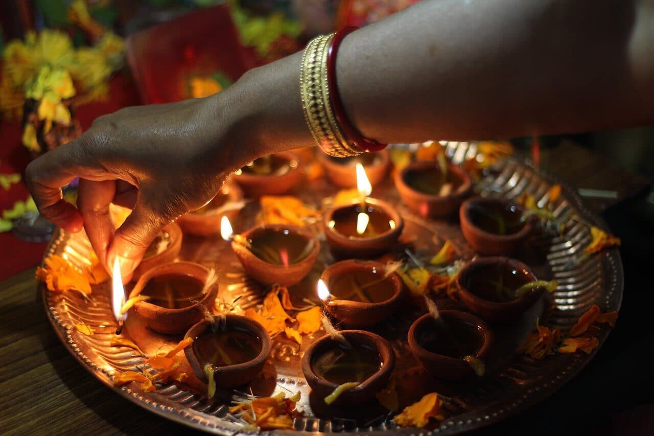 Woman lighting up candles for Diwali