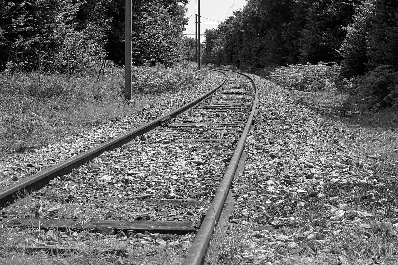 A black-and-white photo of a train track.