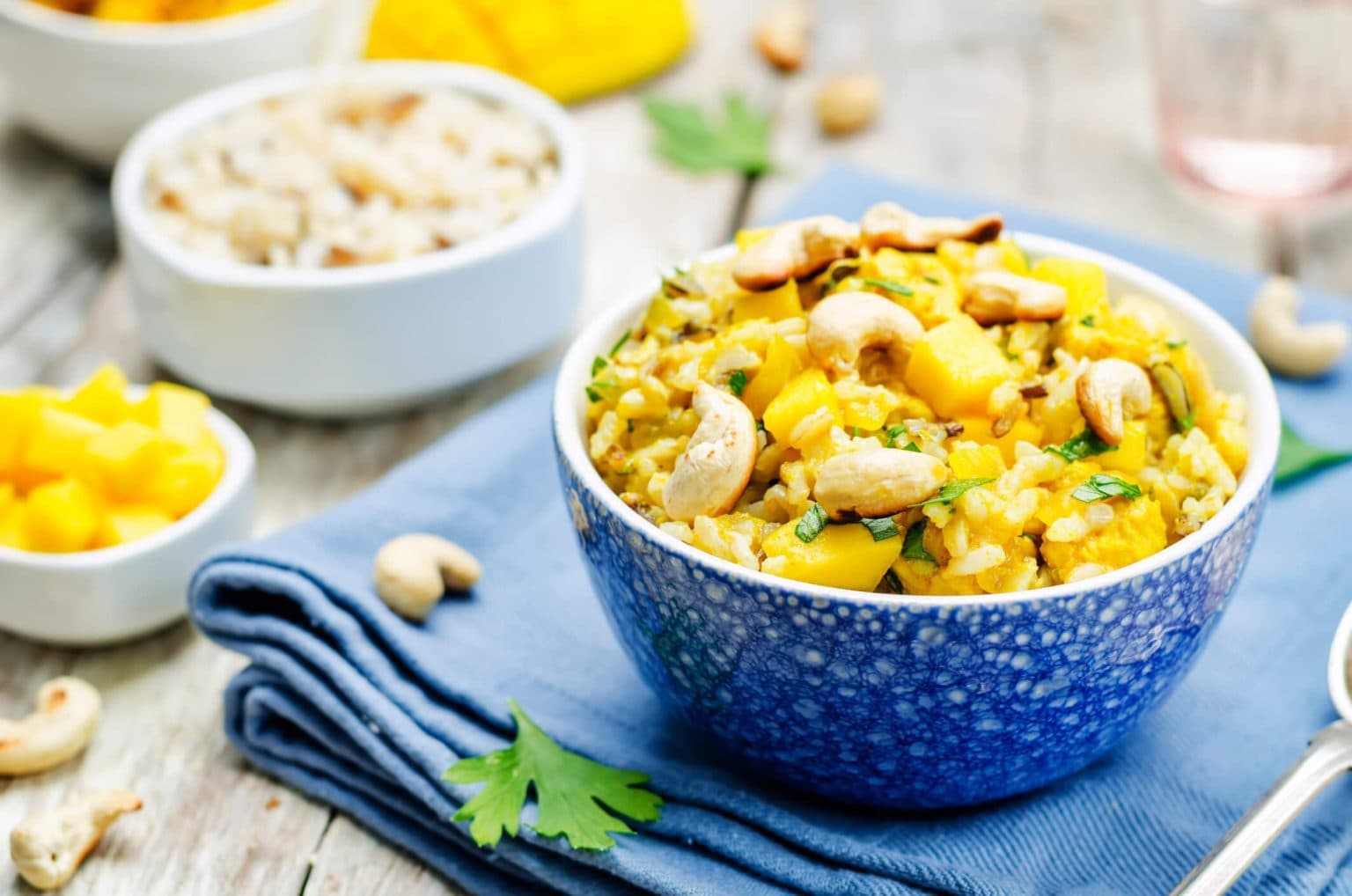 Two bowls with dishes that contain Mango