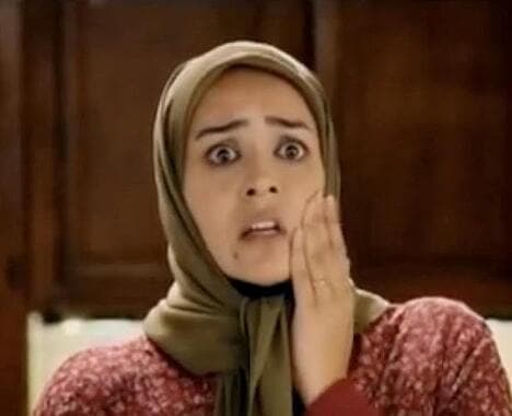 Woman hitting her own face to express "oh no"