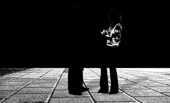 A graphic with the silhouettes of a man and a woman having a conversation outside.
