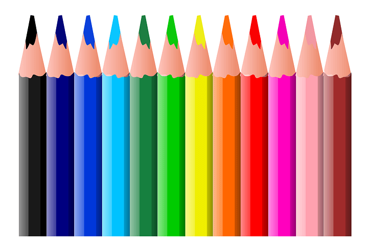 Twelve colored pencils arranged in a rainbow.