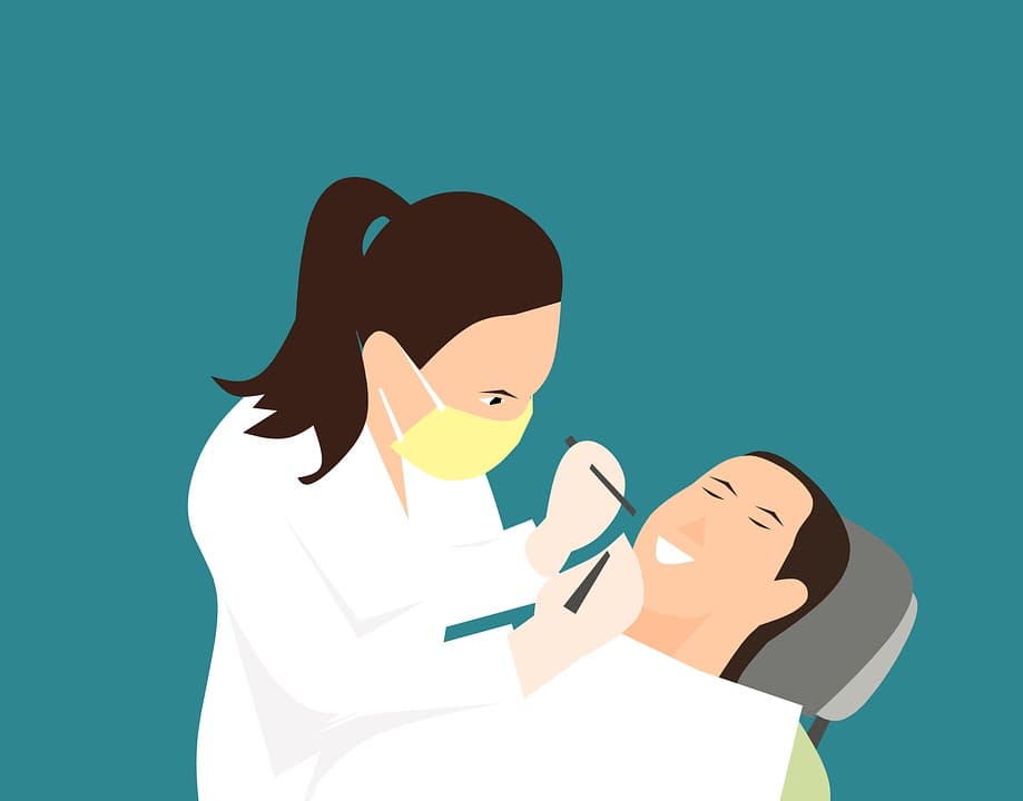 A cllipart graphic of a female dentist leaning over a patient.