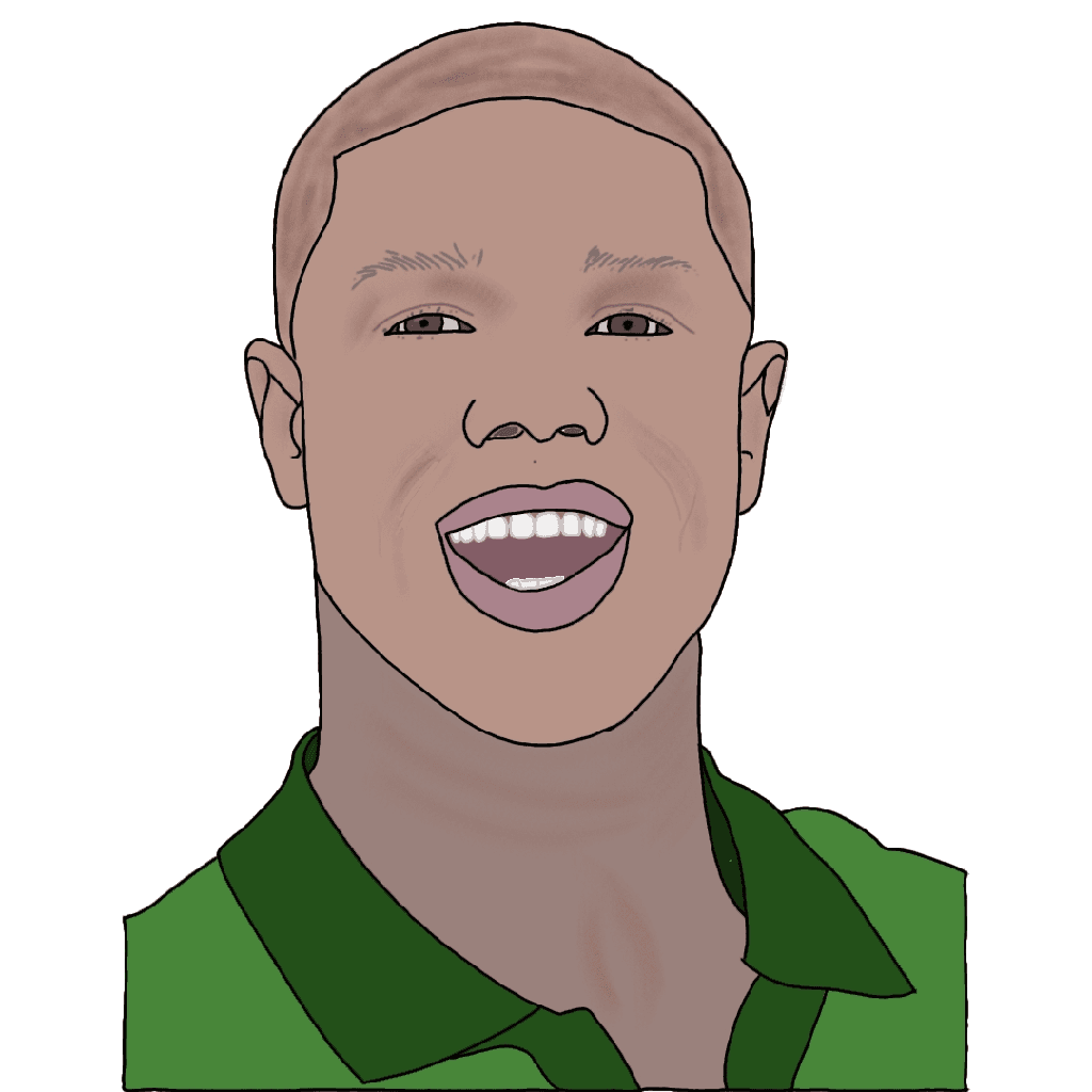 A laughing black man with brown eyes in a green collared shirt.