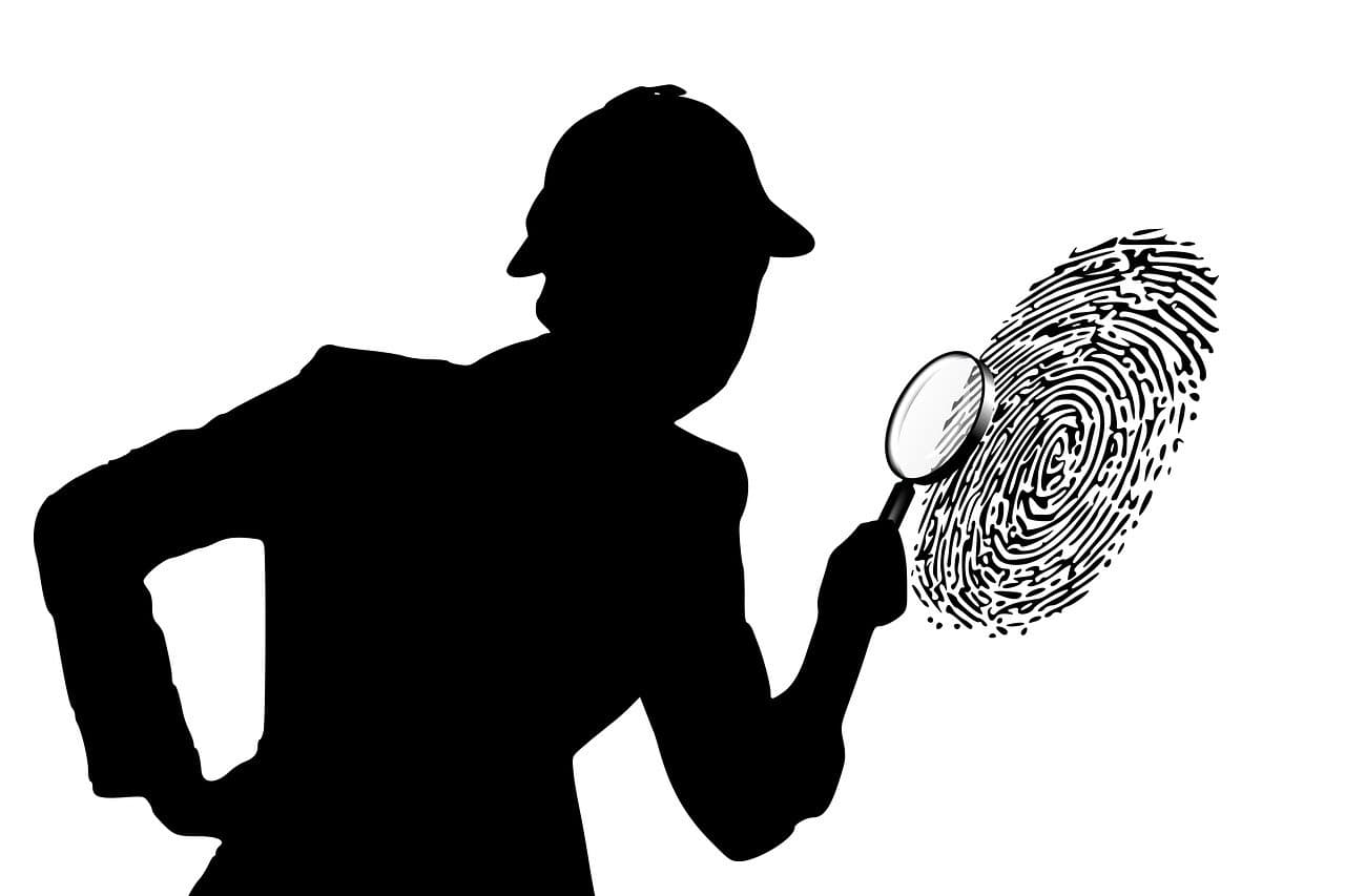A silhouette of a detective looking at a very large finger print through a magnifying glass.