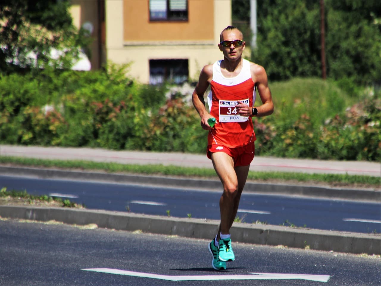 A photo of a marathon runner in a red uniform.