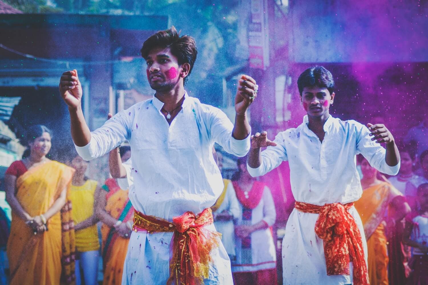 Men during Holi celebrations walking down the street