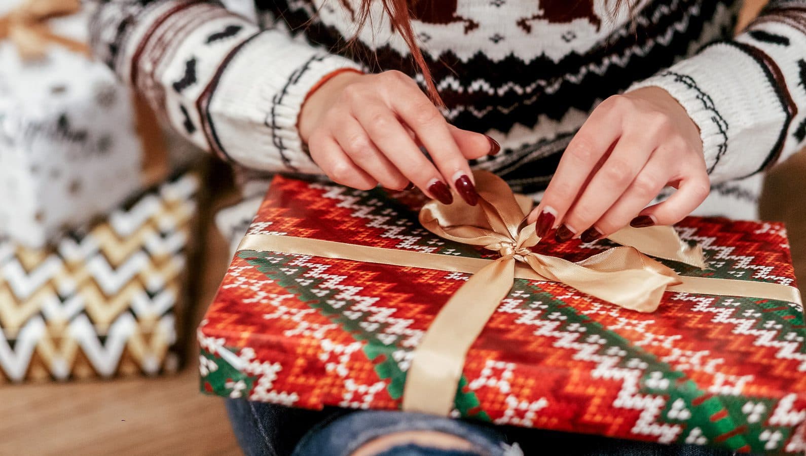 A person opening a Christmas present