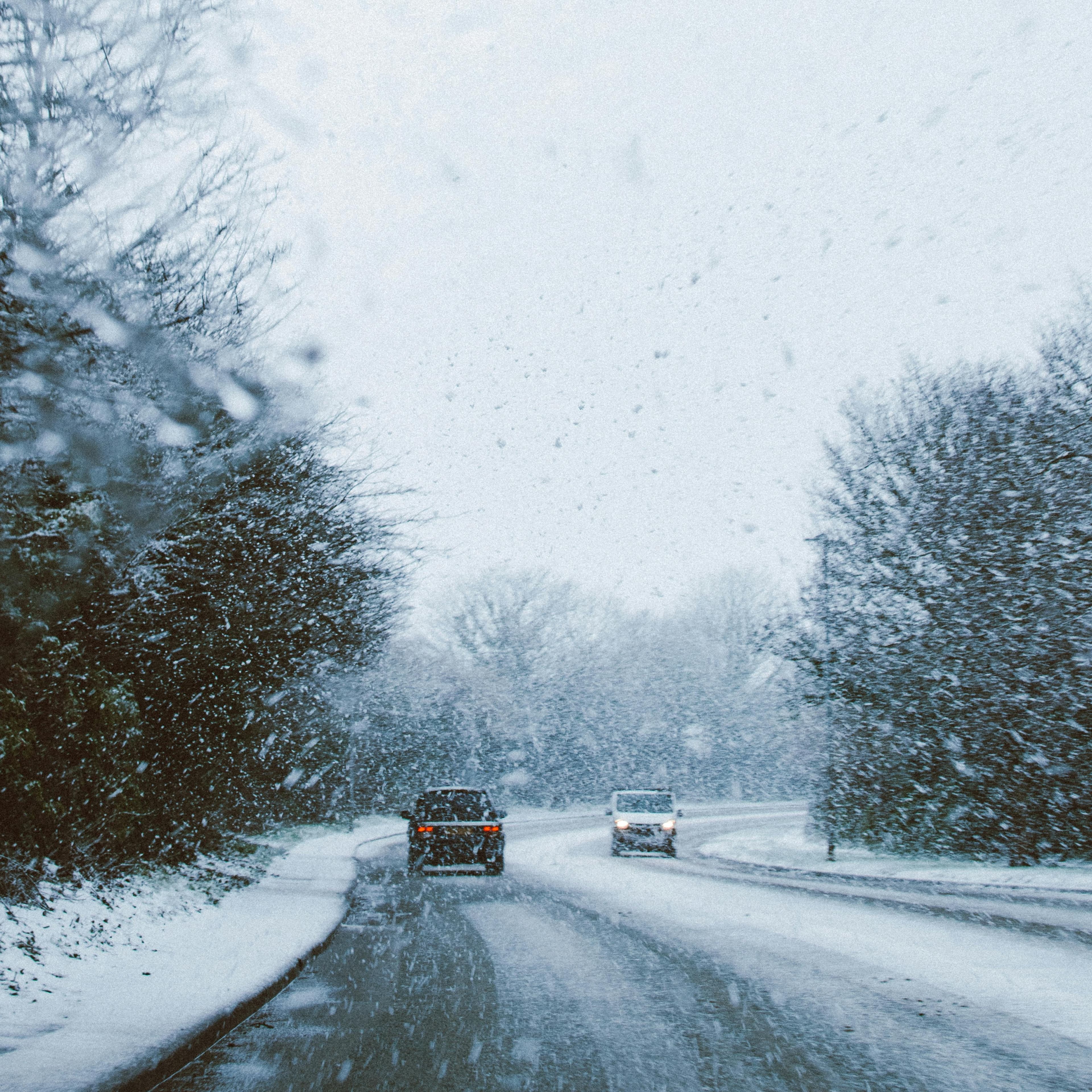 A two-lane road on a snowy day