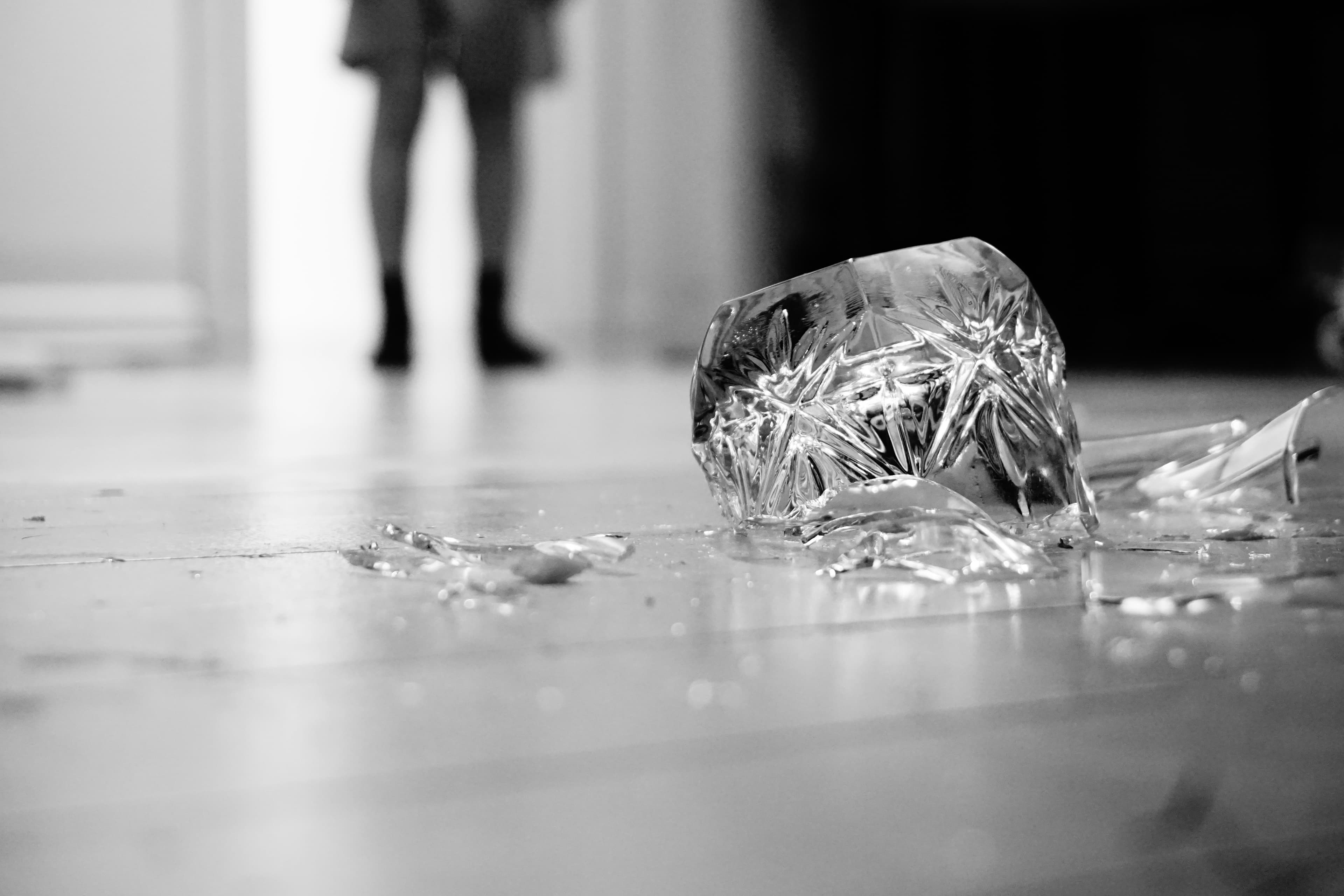 A photo of a broken glass on the floor.