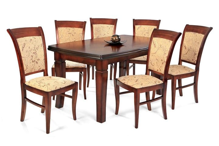 Six wooden chairs around a table.