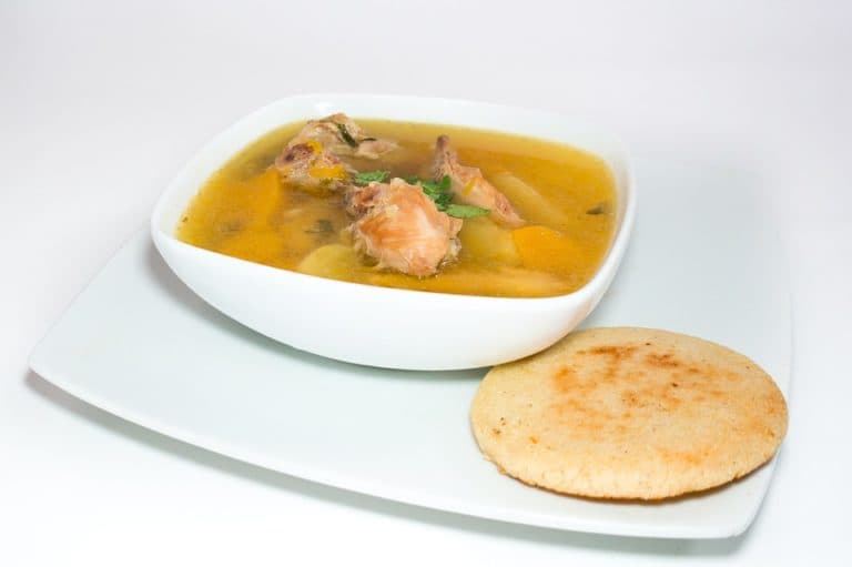 A plate of ajiaco which is a traditional corn-based South American soup
