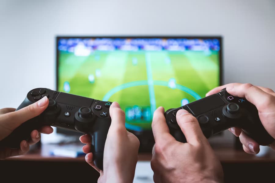 Two people playing a sports game on a Playstation.