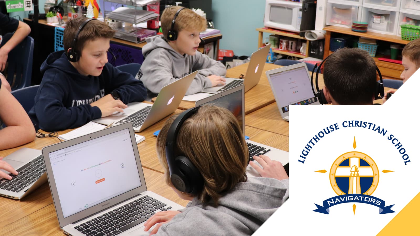 Lighthouse Christian School students working on laptops in headphones, beside the school's Navigators emblem
